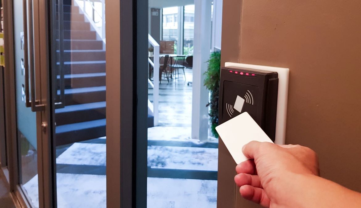 shutterstock_1525486385 A resident uses a key card to enter an apartment building.