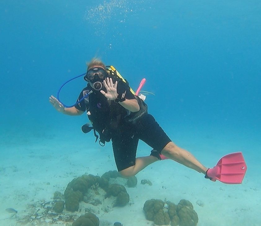Cayce Renshall scuba diving in tropical waters.